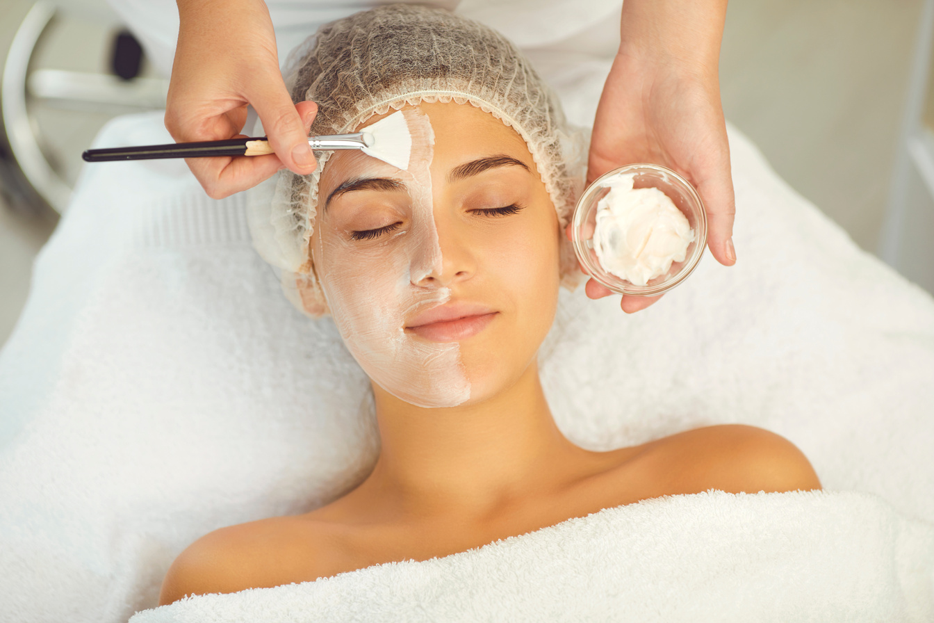 Dermatologist Putting Moisturizing Mask to Womans Face during Skincare Procedure